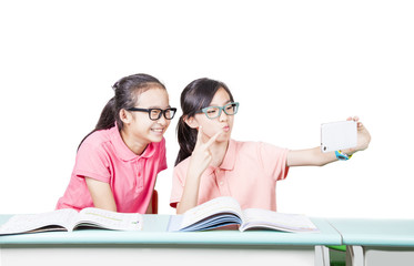 Girl students playing cellphone in the classroom