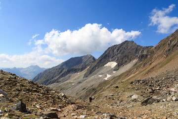 Fototapeta na wymiar Mountain panorama (Kreuzspitze and Zopetspitze) and male mountaineer in Hohe Tauern Alps, Austria