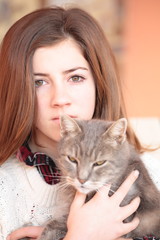 Teenager with her cat in her arms

