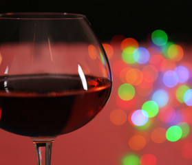 Wine glass with bokeh on dark background