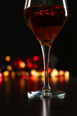 Wine glass with bokeh on dark background