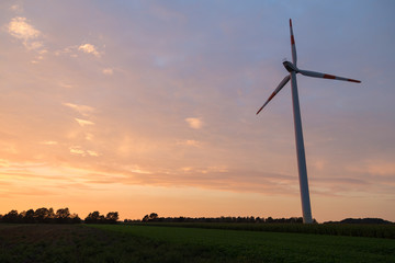 Fototapeta na wymiar Wind power plants during sunset