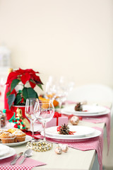 Christmas table setting with holiday decorations on light background