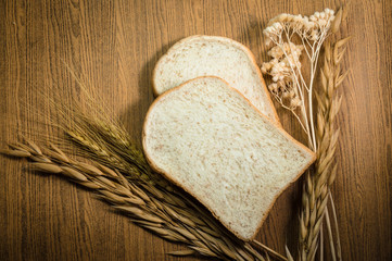 sliced grain bread on wood texture background