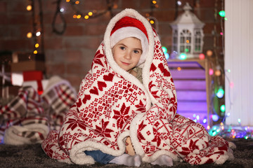 Little boy in plaid at home on a Christmas background