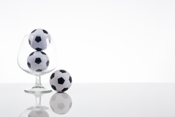 soccer balls in a transparent glass