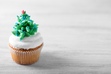 Christmas cupcake on light background