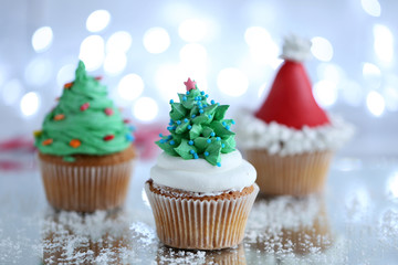 Christmas cupcakes with lights on background