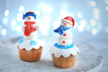 Christmas cupcakes with lights on background