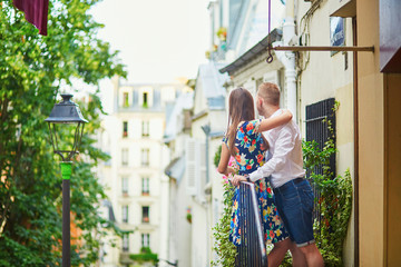 Obraz na płótnie Canvas Romantic couple on the balcony decorated with flowers