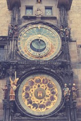 Obraz premium Old Astronomical Clock located on the Town Hall tower in the center of Prague, on a cloudy day. Image filtered in faded, retro, Instagram style with soft focus.