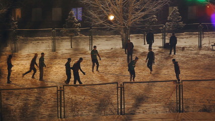 evening soccer practice in the winter outdoors. men. - Powered by Adobe