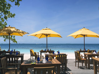 tropical beach restaurant in front of blue ocean