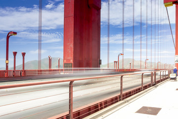 Blurred Trails of Cars and People Passing By on The Golden Gate Bridge