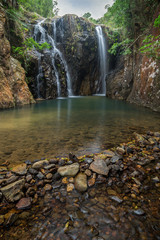 Tai Tam Mound Waterfall, pond and a small dam made of rocks in Hong Kong, China.