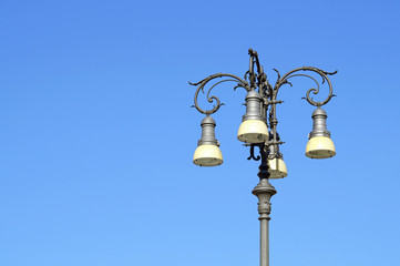 Fototapeta na wymiar lamp street lighting in the Gothic style with the blue sky background