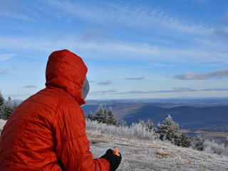 A hiker gazing out on a snow-covered Mount Greylock.