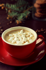 Mug of hot chocolate with marshmallows, on wooden background