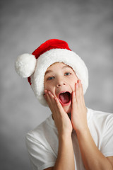 Portrait of cheerful boy on grey background