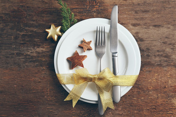 Christmas serving cutlery with plate on a wooden background
