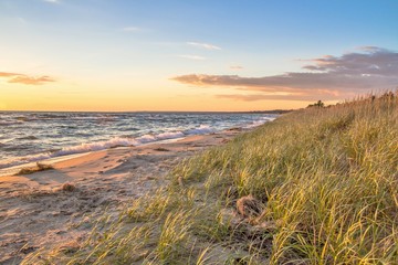 Summer Beach Background.  Remote beach bathed in golden light with sand dunes and dune grass. St. Ignace, Michigan.