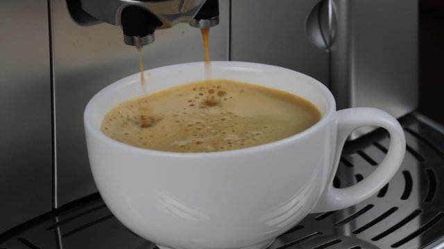 Coffee machine pouring espresso in cup macro image. ( 1080 HD Silent Video )
