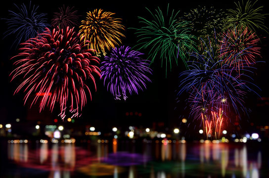Fireworks celebration and the city night light background.