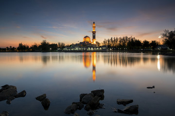 Naklejka premium Perfect reflection of a floating mosque Masjid Tengku Tengah Zaharah in Kuala Ibai, Terengganu, Malaysia during sunset