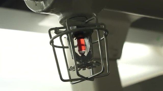 Details of a sprinkler system outlet and thermostat.  Hand help clip, stabilized.