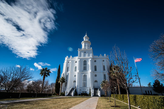 St. George Utah Temple with American Flag Under Winter Blue Sky