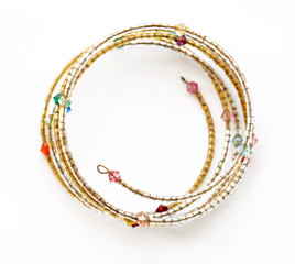 Bright bracelet with different beads on white background