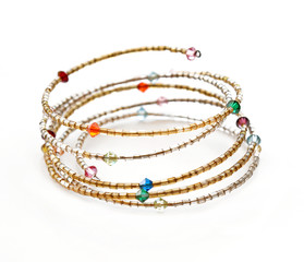 Bright bracelet with different beads on white background