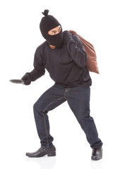 Burglar in mask holding knife on white background
