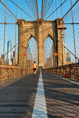 Jogger running along the Brooklyn Bridge