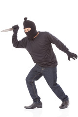 Fototapeta na wymiar Burglar in mask holding knife on white background