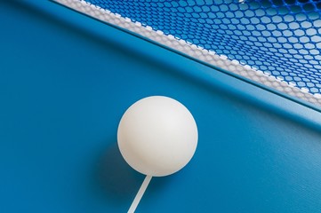 Sport concept. Ping pong ball on blue table for playing table tennis.