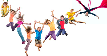 group of happy cheerful sportive children jumping and dancing