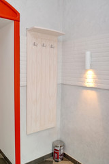 Hanger for outerwear and a sconce in a modern interior