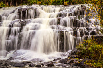 Bond Falls. Beautiful Bond Falls in autumn with leaves rushing over the cascade. Paulding, Michigan.