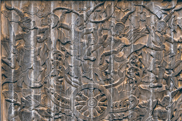 Thai wood carving of people, life style and fine art on  big pie