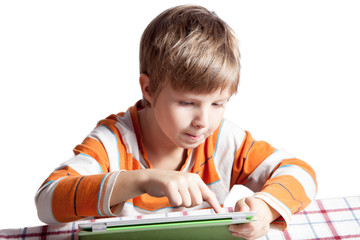 A boy who is engaged with a tablet computer