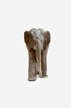 Thai wood carving of baby elephant on a white background