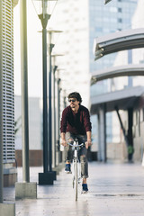 Handsome young man on bike in the city