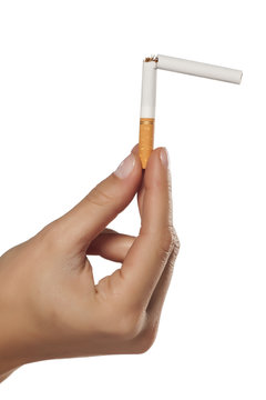 female hand holding a broken cigarette