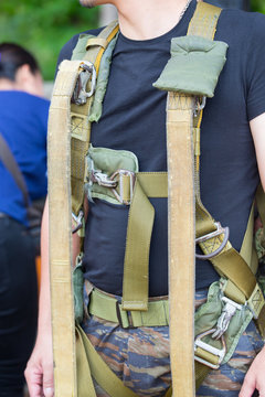 man wearing training parachute gear on body