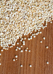 white quinoa on wooden background