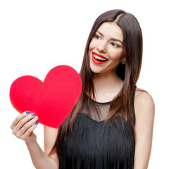 Beautiful woman holding heart shaped valentine card and smiling