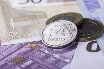 coin ruble against the background of Euro banknotes