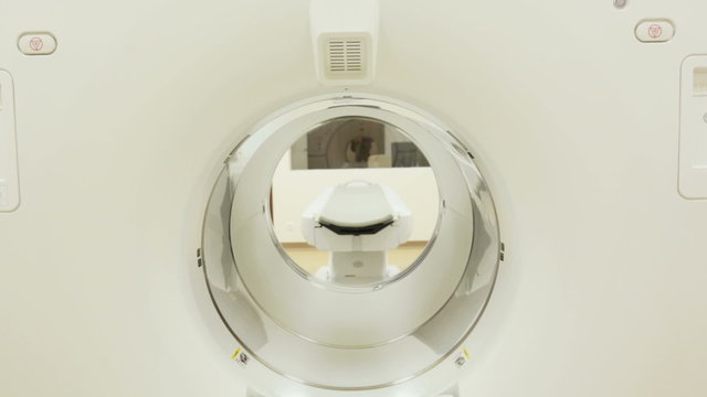 A CT scan, also called X-ray computed tomography (X-ray CT) or computerized axial tomography scan (CAT scan) in a new modern cancer treatment hospital. Zoom out.