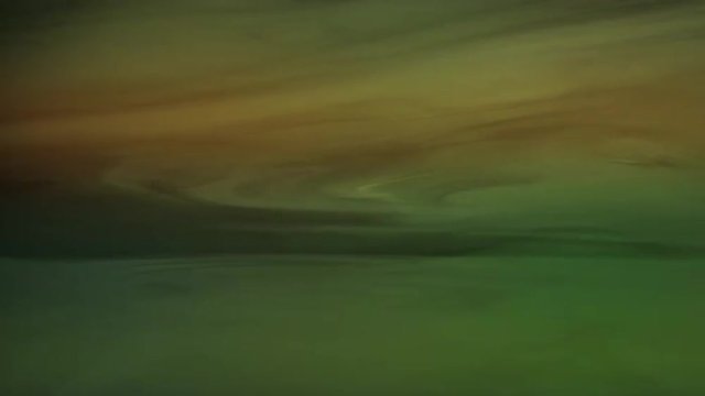 Green, yellow and orange tinted fog drifts across the screen, resembling planetary gas clouds.  Recorded against black and intended as a motion graphics background or for compositing.  Looping clip.